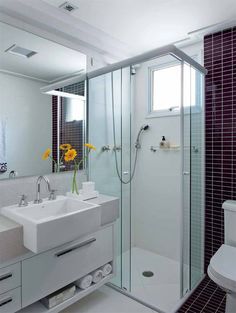 a bathroom with a sink, toilet and shower stall in the middle of it's walls