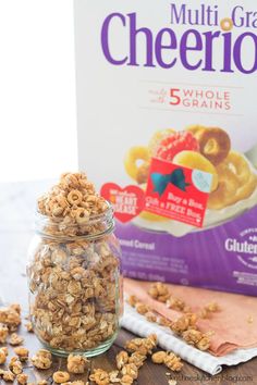 granola in a glass jar next to a box of cheerios