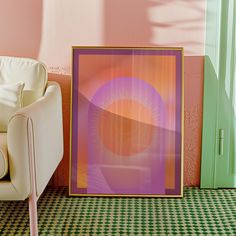 a chair sitting in front of a painting on the wall next to a white couch