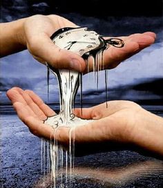 two hands holding water dripping from the top of each other, with a sky in the background