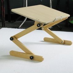 a small wooden table sitting on top of a white floor