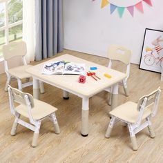 a child's table and chairs in a room