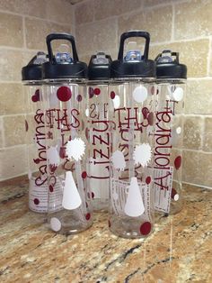 three water bottles sitting on top of a counter