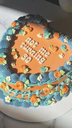 a blue and orange birthday cake with the words happy birthday on it's frosting