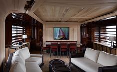 a living room filled with lots of furniture next to a dining room table and chairs