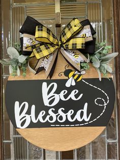 a sign that says bee blessed hanging on the front door with a ribbon around it