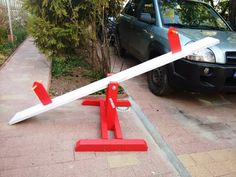 a car parked next to a pole that has been knocked over