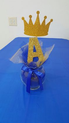 a blue table with a gold crown on it and a blue ribbon around the top