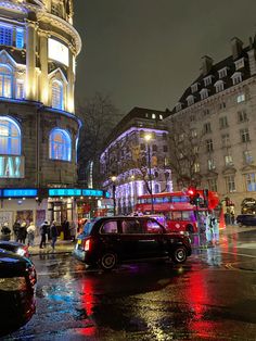 a busy city street at night with cars and pedestrians