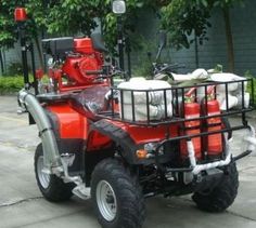 a red four wheeler is parked on the street