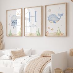 two framed pictures hang above a bed in a child's bedroom