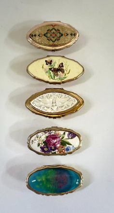 five decorative plates are lined up in a row