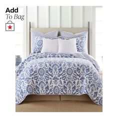 a blue and white comforter set with pillows