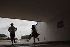 two people are running under an overpass