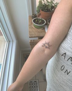 a woman with a small tattoo on her arm