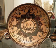 an antique bowl is on display in a museum