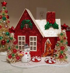 a small red house decorated with christmas decorations