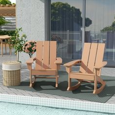 two wooden rocking chairs sitting next to a swimming pool