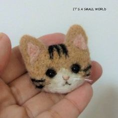 a small stuffed animal in the palm of someone's hand