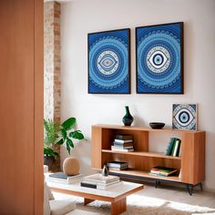 two paintings on the wall above a coffee table