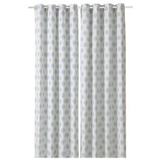 a pair of polka dot curtains with white and blue dots on the curtain rod ends