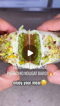 two hands holding a hot dog with condiments on it and the caption reads, healthy homemade pistachio nougat bars enjoy your meal