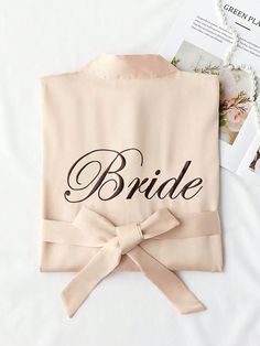 a bride shirt with a bow on the front and matching name written on the back