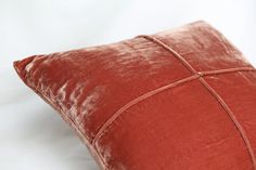 a red pillow on a white background