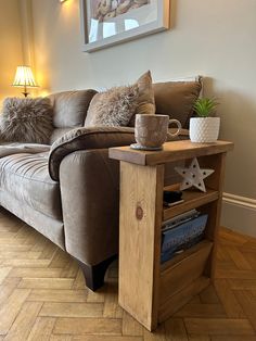 a living room with a couch, coffee table and lamp