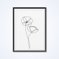 a black and white drawing of two flowers in a frame on the wall next to a plant