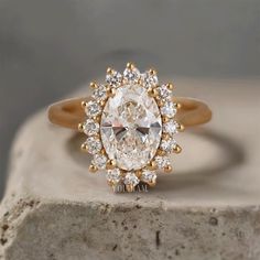 a close up of a diamond ring on a rock