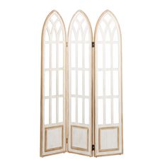 a white room divider with three arched windows