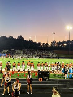 the cheerleaders are lined up on the field