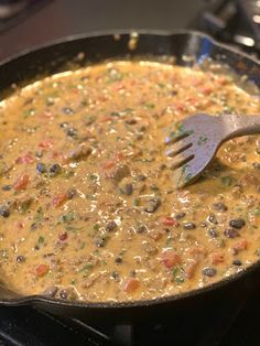 a skillet filled with food sitting on top of a stove