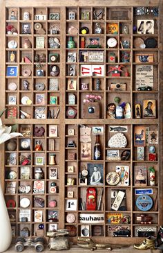 a wooden box filled with lots of different types of buttons and magnets on top of a table