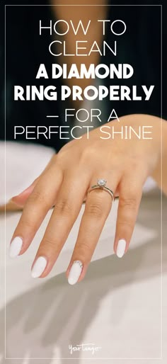 a woman's hand with white nail polish on it and the words how to clean a diamond ring properly for a perfect shine