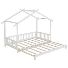 a white doll house bed frame with wooden slats