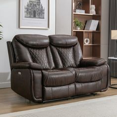 a brown leather reclining loveseat in a living room