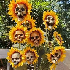 a bunch of sunflowers with skulls on them