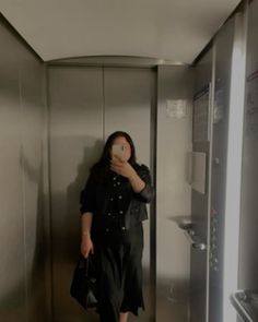 a woman taking a selfie in an elevator