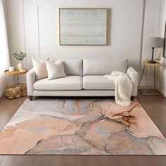 a living room with a white couch and rug