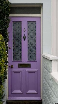 a purple front door with glass panels