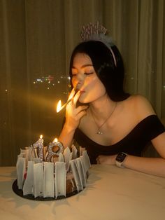 a woman blowing out candles on her birthday cake