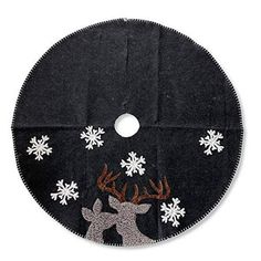 a black christmas tree skirt with white snowflakes and reindeers on it's face