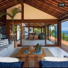 a living room filled with furniture and an ocean view