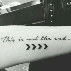 this is not the end tattoo on someone's arm