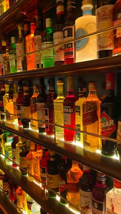 many bottles of alcohol are lined up on the shelves