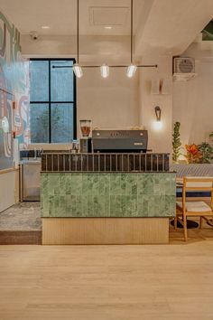 the interior of a restaurant with green tile counter tops