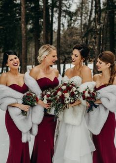 three bridesmaids in red dresses and fur stoles