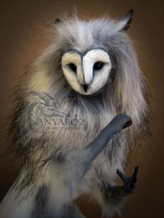 a stuffed animal with long hair and an owl like look on it's face